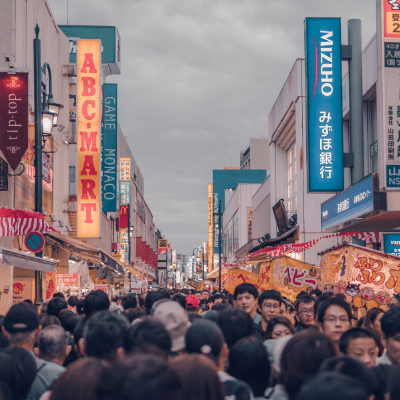 many shoppers walking along Japanese market street